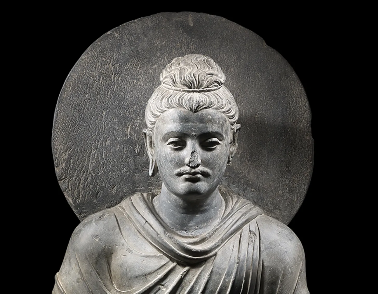 Close up look of : A grey schist figure of Buddha Shakyamuni